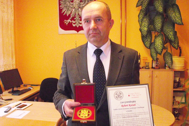 CKZiU w Strzelinie zostało wyróżnione za akcję krwiodawstwa. Dyrektor szkoły Robert Kozuń pokazuje list gratulacyjny oraz pamiątkowy medal